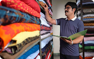 Shop owner browsing fabrics